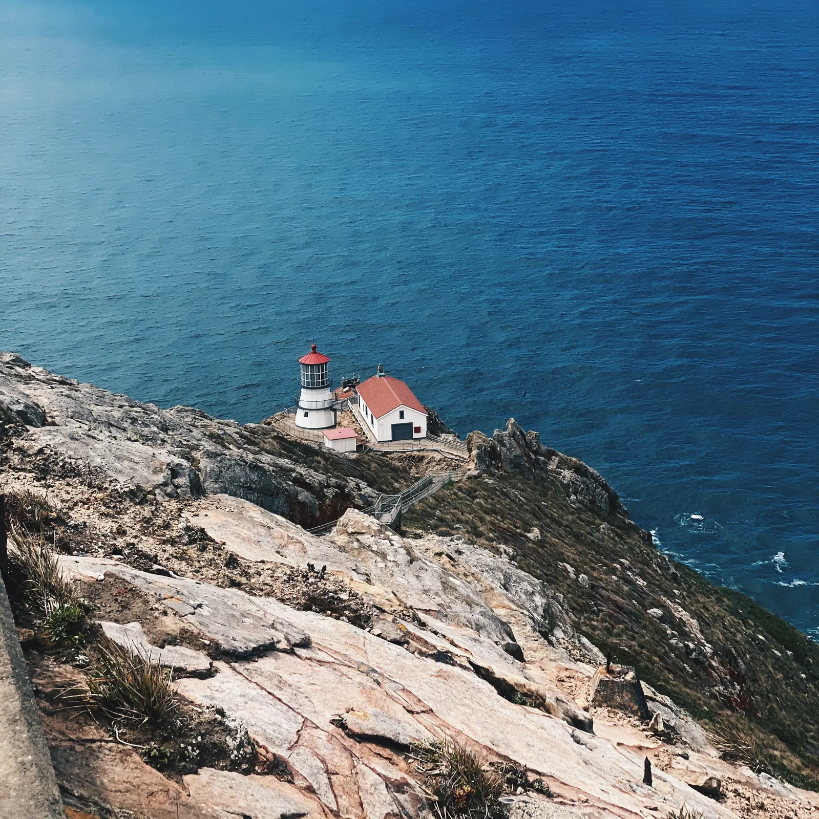 Point Reyes lighthouse on a rocky cliff above the Pacific Ocean